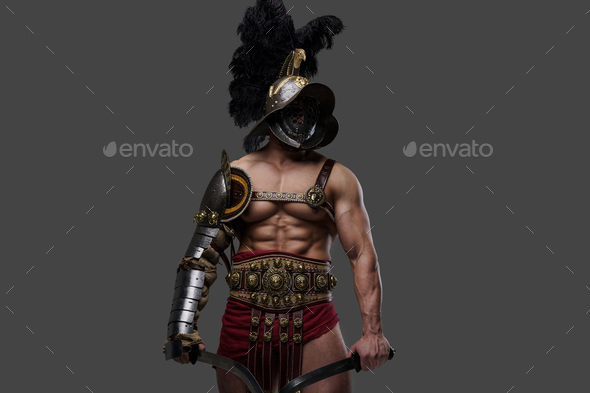 Aggressive Roman Gladiator With Naked Torso Dual Wielding Swords Stock